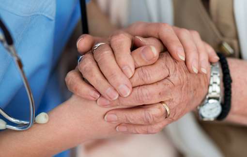 carer holding person's hand