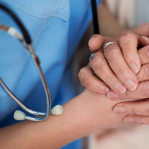 carer holding person's hand