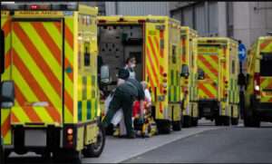 queue of ambulances outside a hospital's A&E department.