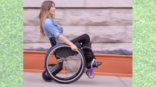 Woman riding a wheelchair using a powered add on.
