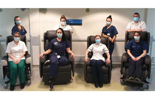 Healthcare workers in a hospital ward pictured with the Lento specialist patient seating range.