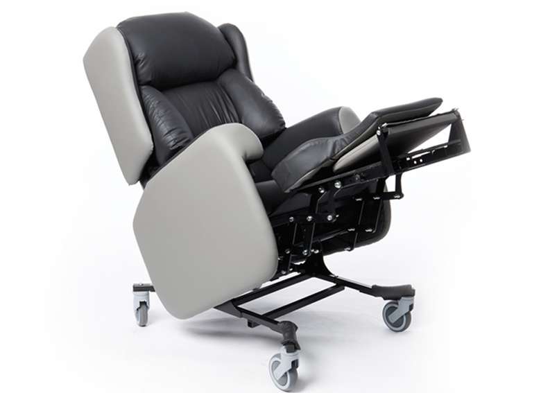 Product shot of a reclined lento adjustable care chair with leg rest elongated.