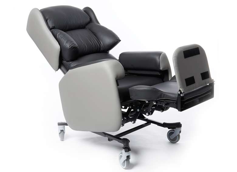 Product shot of a reclined lento adjustable care chair with legrest elongated and footrest out.