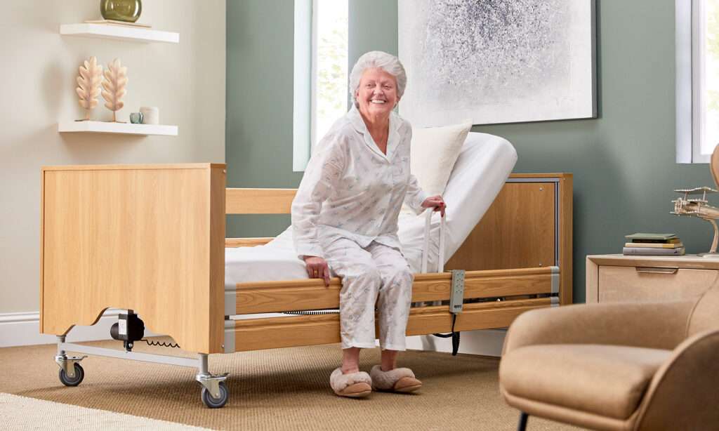 Elderly woman getting out an electric recliner bed, the bed is an Opera classic comfort electric profiling bed. She is insider her home, in her bedroom.