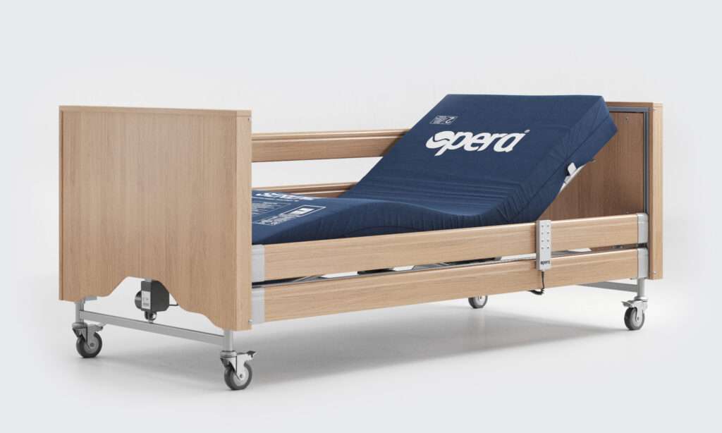 Product shot of the Opera Signature Comfort electric profiling care bed. The bed is in a profiling motion and features a pressure wound care mattress.