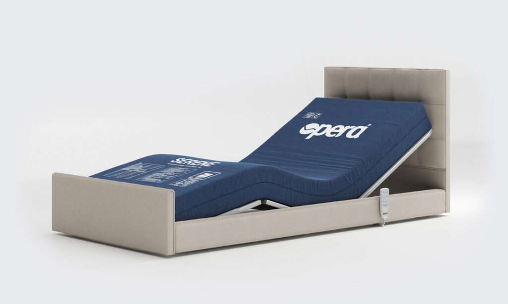 Product shot of the electrically controlled solo comfort profiling mobility recliner bed in a reclining position with pressure relief mattress visible.