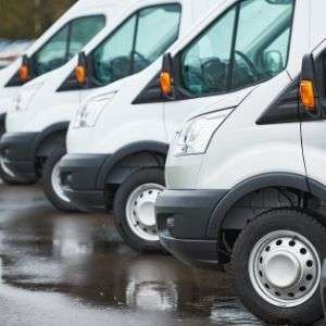 Row of Vivid.Care vans. Offering wheelchair servicing & mobility scooter repair.