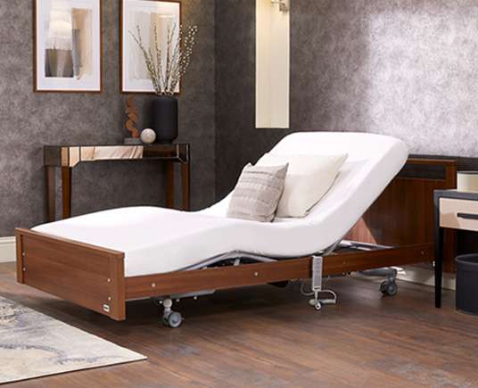 Lifestyle shot of the Signature low footboard electric profiling bed.