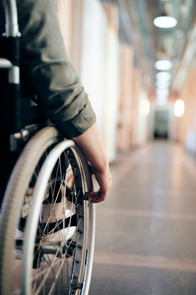 Close up of a wheelchair in a hallway.