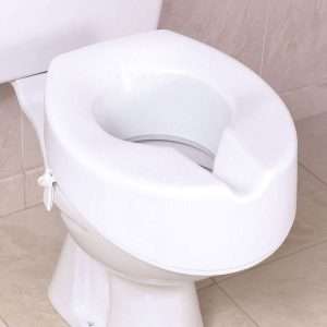 A raised foam toilet seat strapped to a toilet to provide extra height 