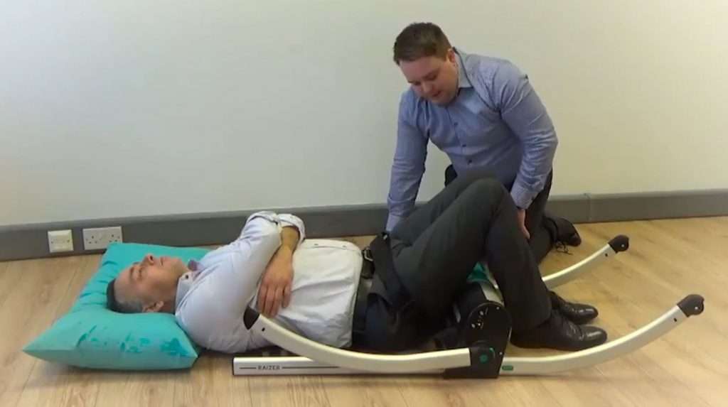 The Raizer lifting chair completely assembled flat to the ground beneath a fallen person.