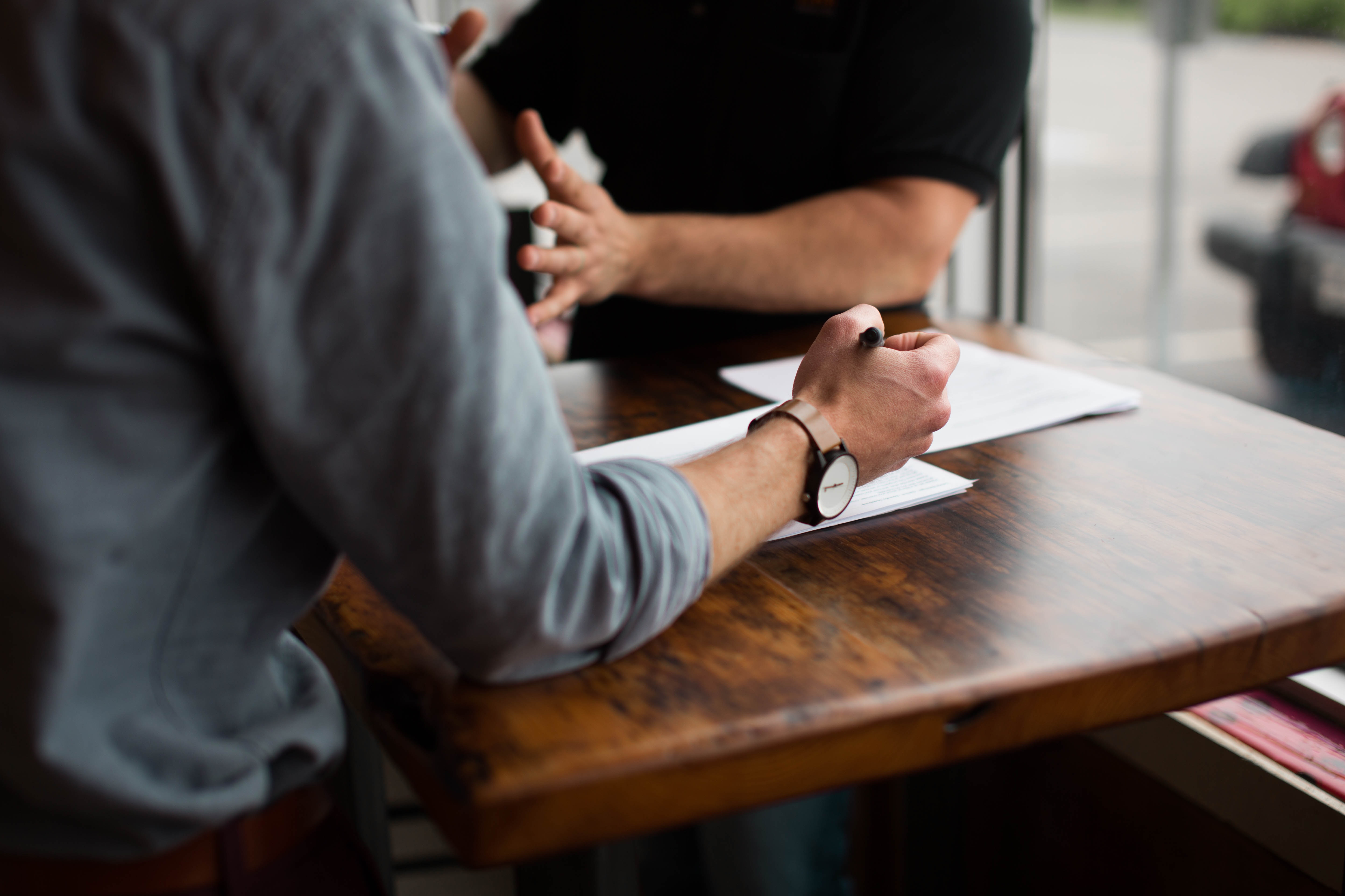 Two people sat at a table talking.