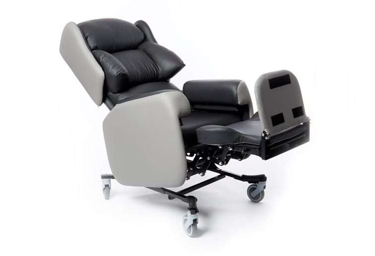 An original Lento care chair with the legrest raised and the backrest reclined