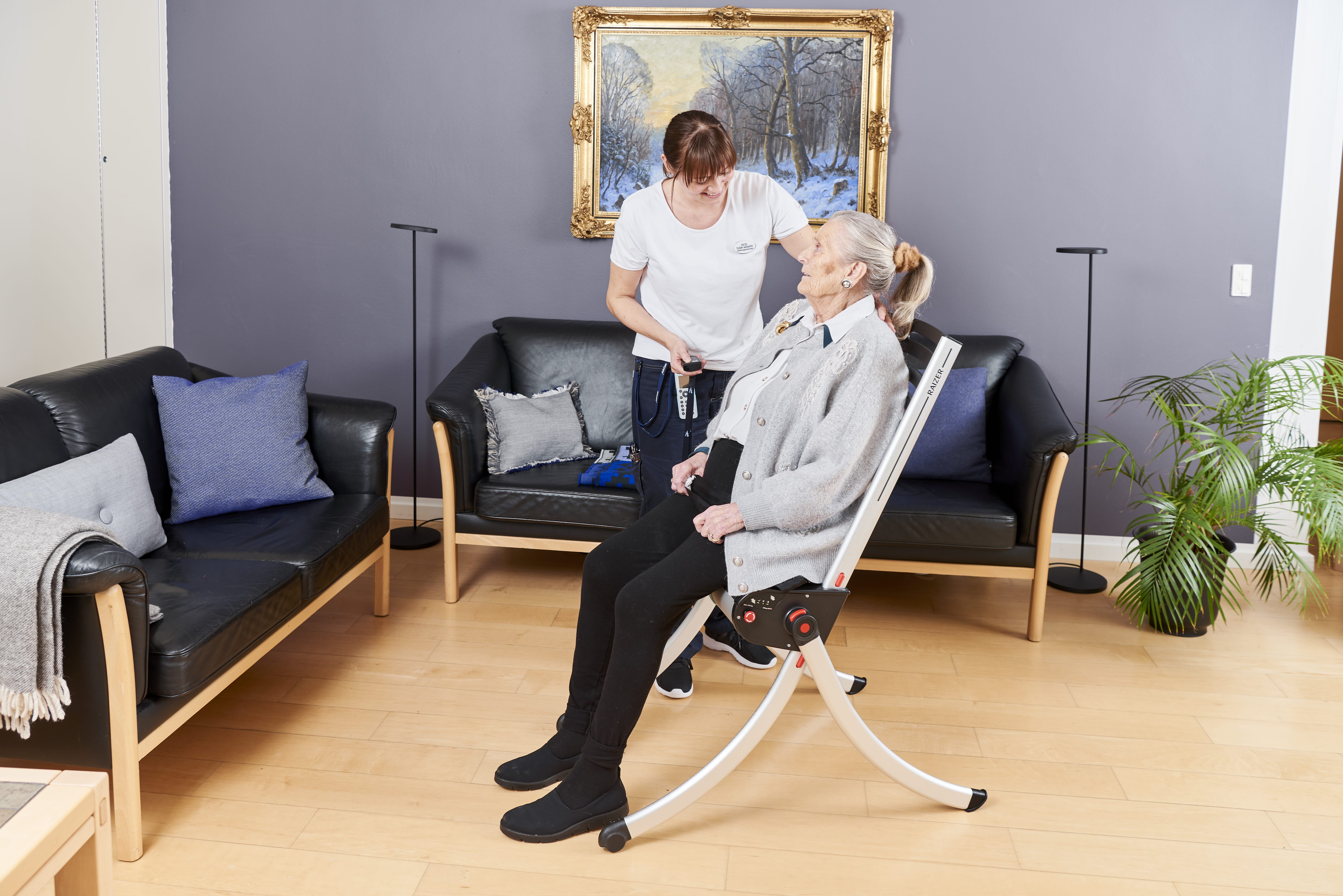 A lady sat on the Raizer lifting chair after being lifted up.