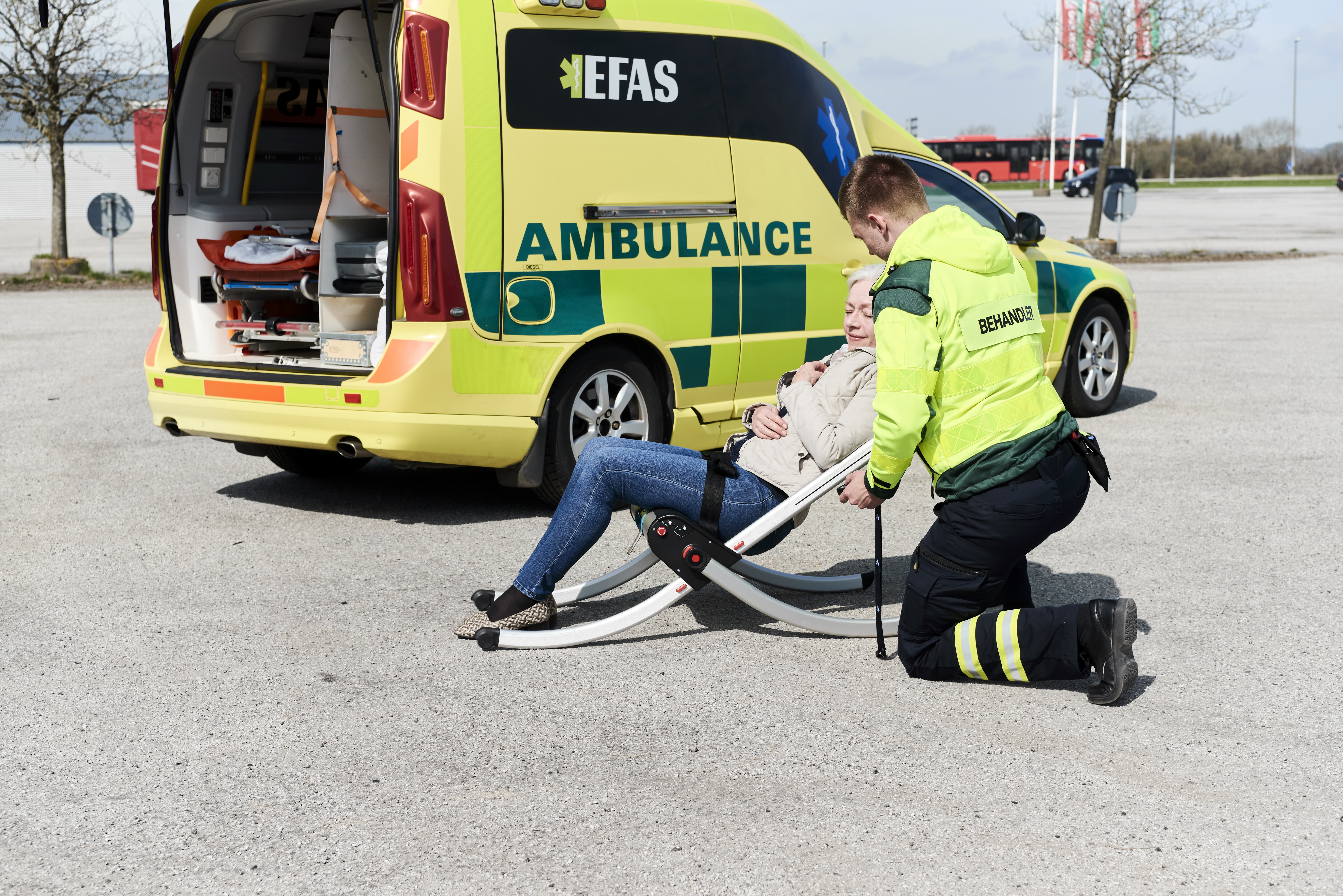 A paramedic lifting a fallen lady from the floor using the Raizer