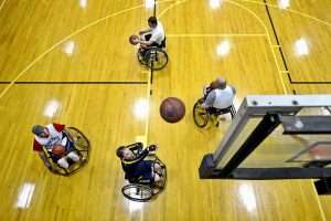 Four men playing wheelchair basketball