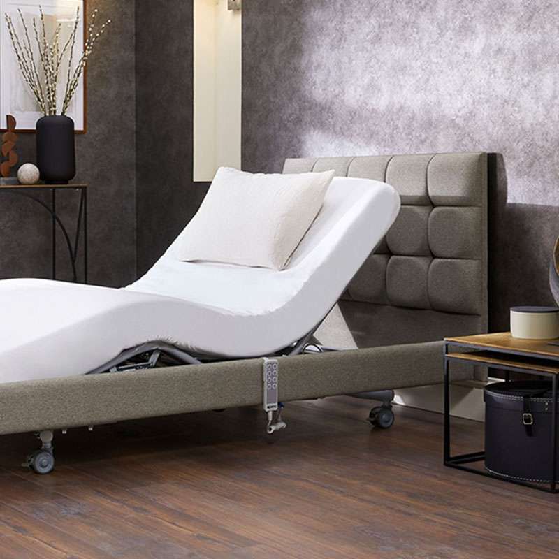 Lifestyle shot of an electric adjustable bed in the Vivid Care Harrogate mobility shop showroom.