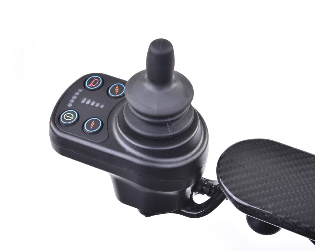 Close up of the electric joystick control of the Quickie q50r lightweight carbon fibre foldable compact wheelchair.