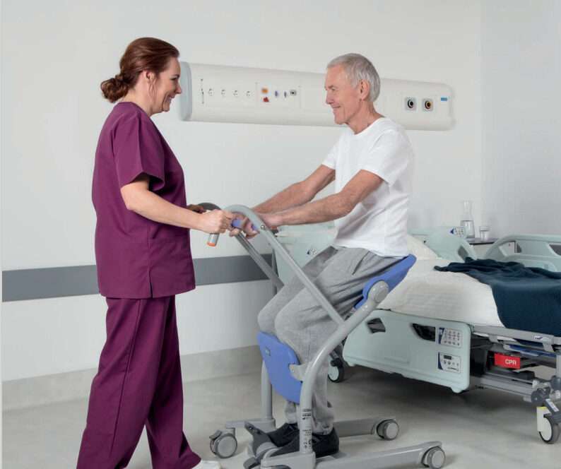 Graphic showing a patient chair and standing hoist mobility aid comparison for a vs article.