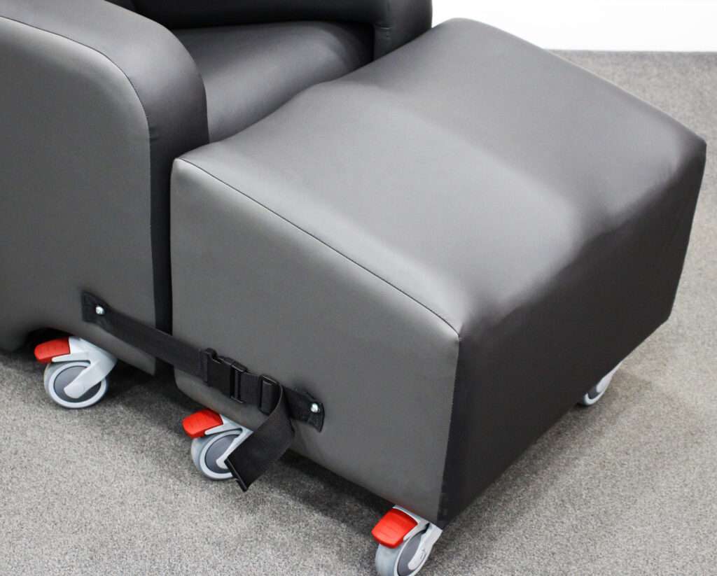 Product shot of the Lento Neuro disability recliner chair with wheels. Close up of the footrest.