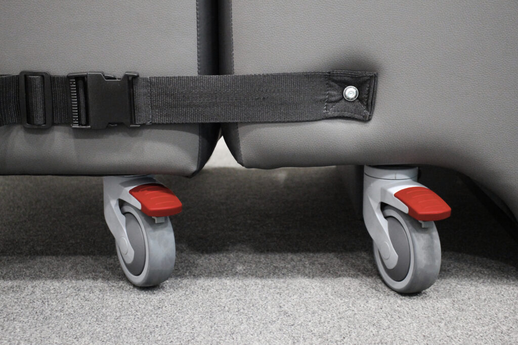 Product shot of the Lento Neuro disability recliner chair with wheels. Close up of the wheels