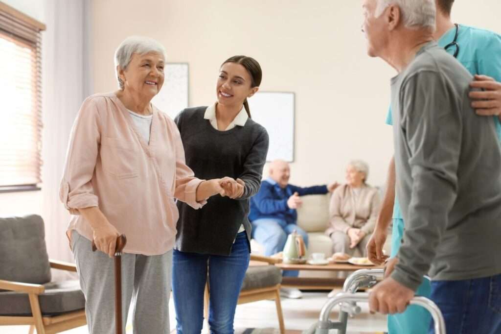 nurse helping elderly woman