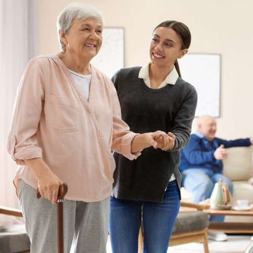 young nurse helping elderly lady