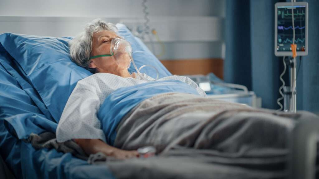 elderly female patient lying in hospital bed