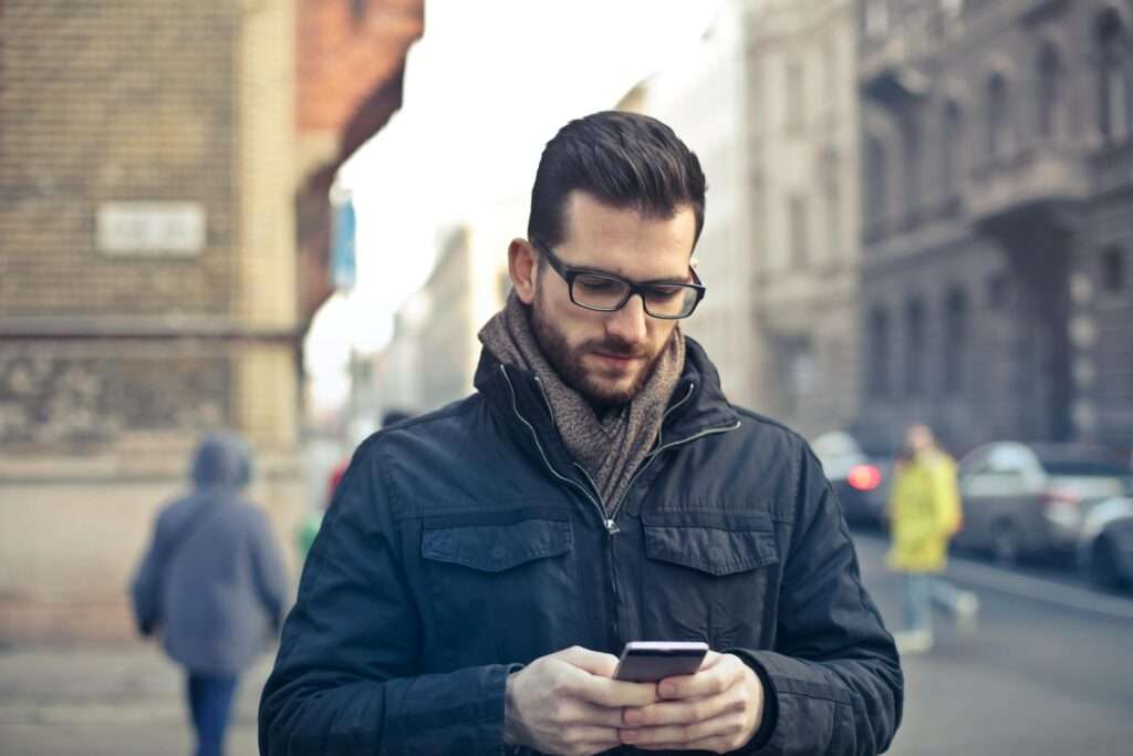 man looking down at phone 