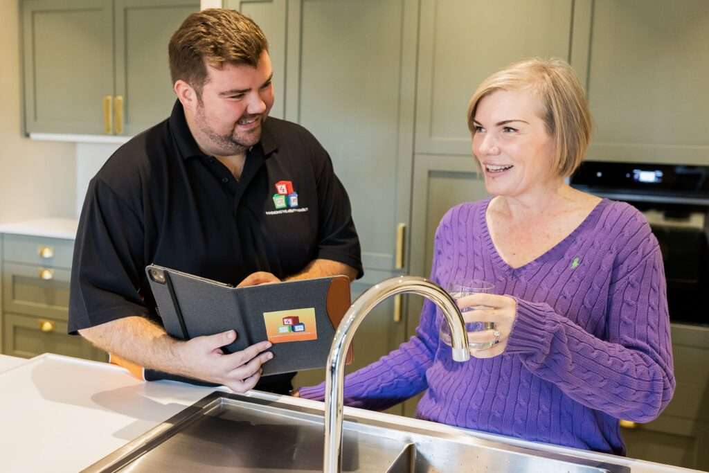 OT helping client at kitchen sink