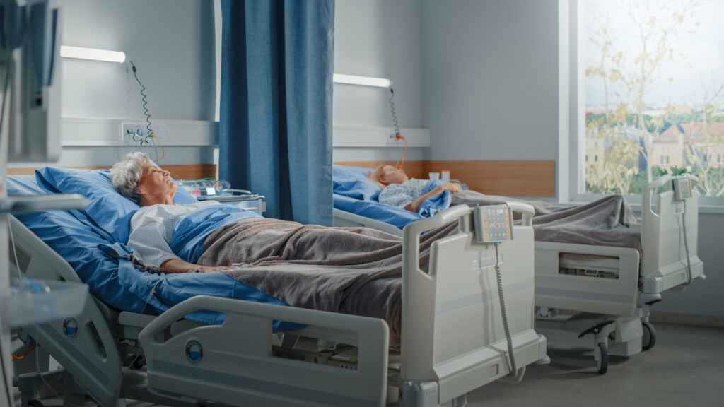 Hospital Ward: Elderly Old Lady and Young Beautiful Girl Resting in Beds, Fully Recovering from Successful Surgeries. Patients Restore Health after Sickness. Modern Clinic With Sunny Window View